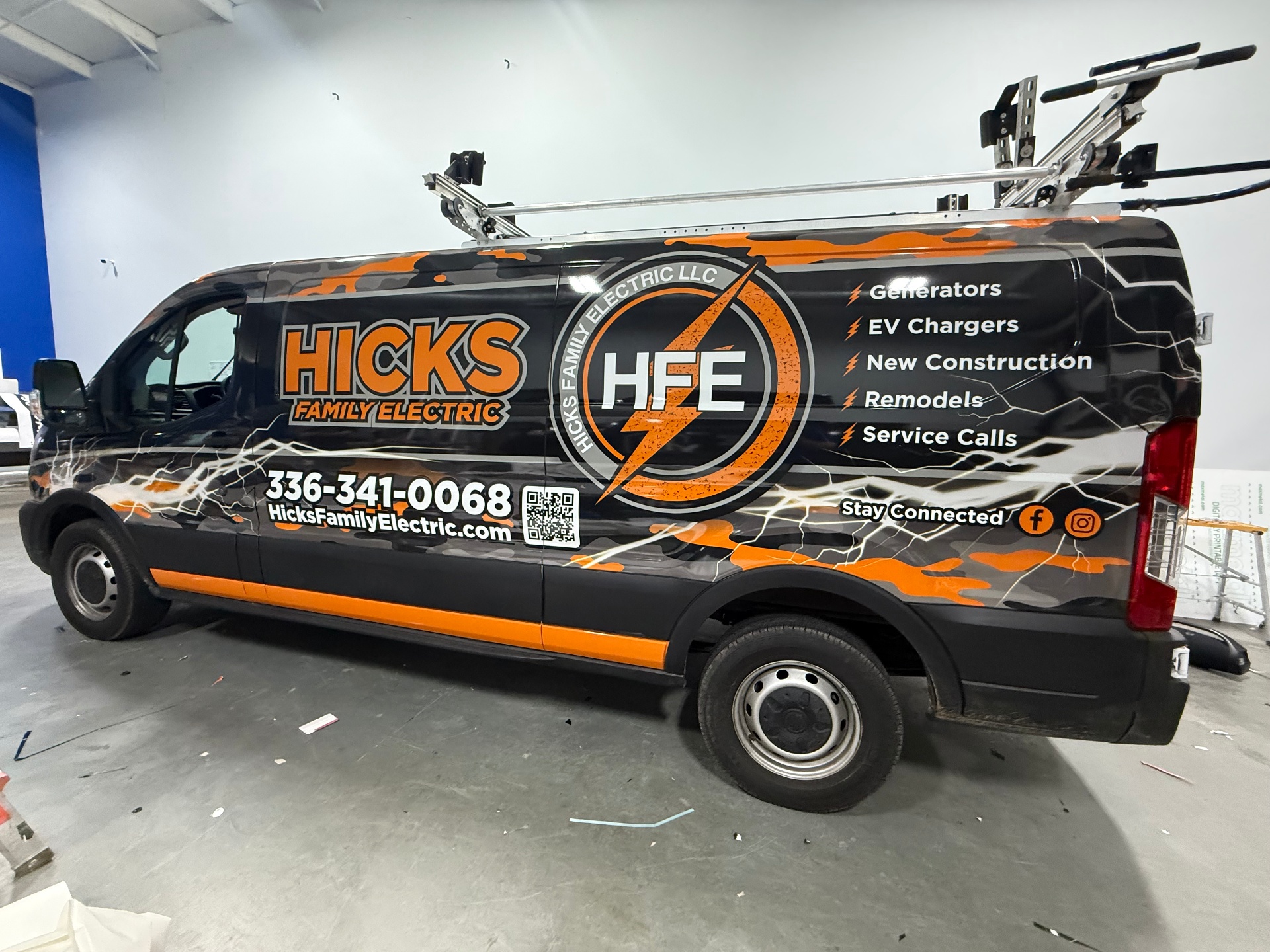 Hicks Family Electric Ford Transit van wrap with orange lightning graphics